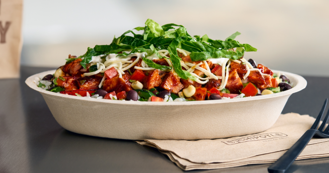 A Chipotle Honey Chicken Burrito Bowl with White Rice, Black Beans, Fajita Veggies, freshly grilled chicken, Fresh Tomato Salsa, hand-mashed Guac, and Monterey Jack shredded cheese.